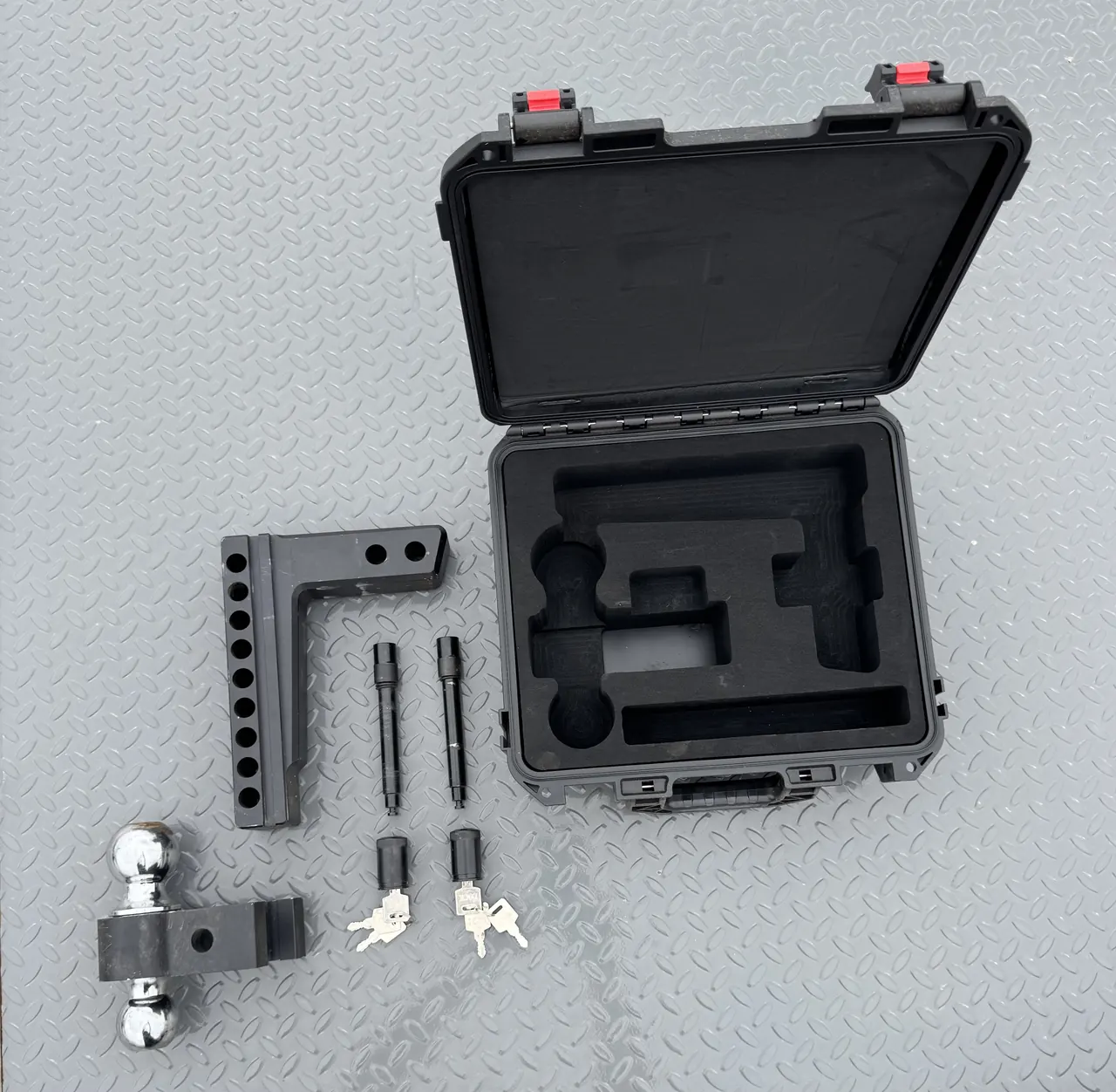 Adjustable drop hitch with 2 inch and 2 5/16 inch balls, locking pins and keys in a hard case
